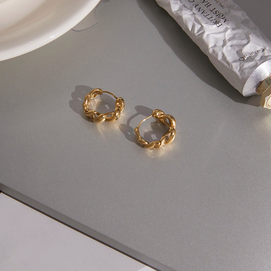 Kika Classic Glossy Hollow Out Wrapped Wave Earrings