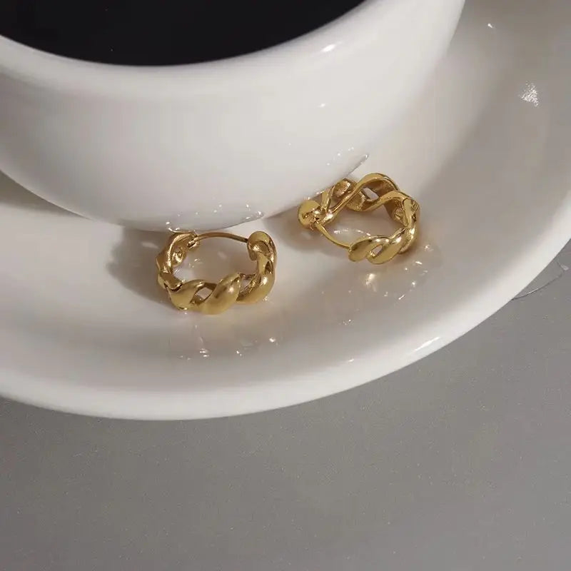 Kika Classic Glossy Hollow Out Wrapped Wave Earrings